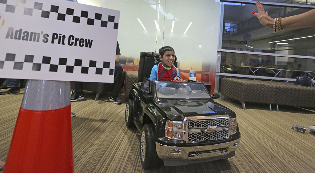 <p>In this Wednesday, May 24 photo, Adam Ahmed, 6, gets excited about his opportunity to drive a toy car as he arrives on site as special needs children enjoy driving motorized toy cars at the Frisco ISD Career and Technical Education Center in Frisco, Texas. (Louis DeLuca/The Dallas Morning News via AP)</p>