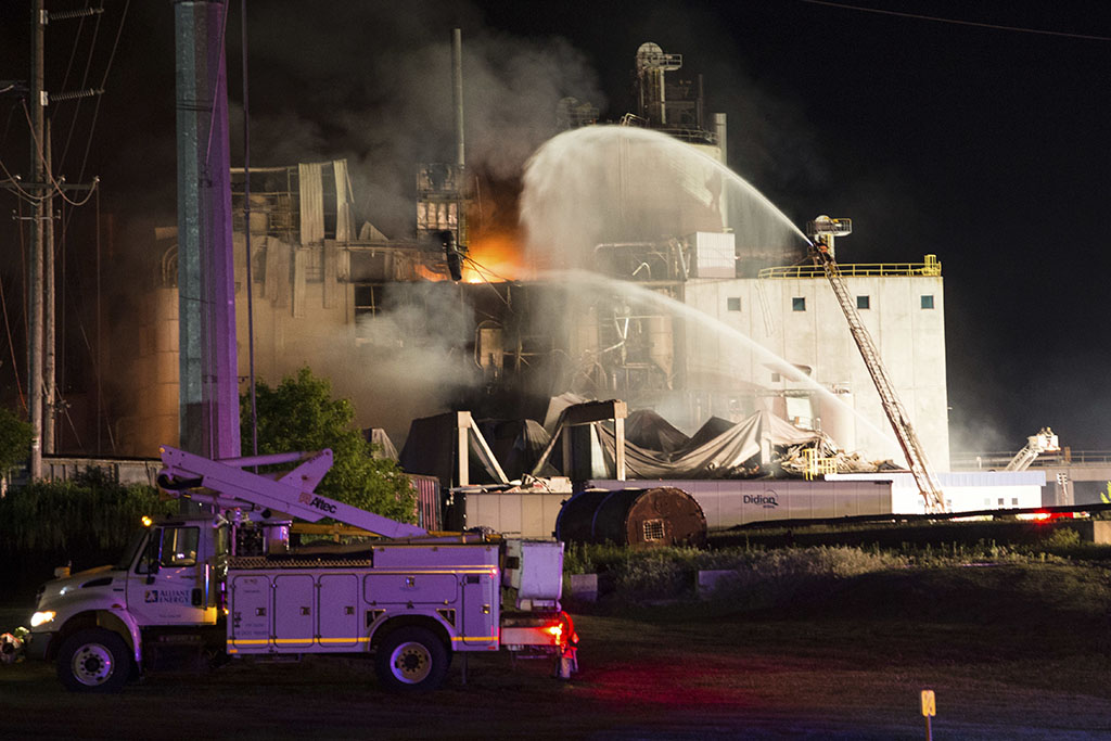 <p>In this photo provided by Jeff Lange, firefighters work at the scene following an explosion and fire at the Didion Milling plant in Cambria, Wisconsin, Thursday, June 1, 2017. Recovery crews searched a mountain of debris June 1 following a fatal explosion late Wednesday at the corn mill plant, which injured about a dozen people and leveled parts of the sprawling facility in southern Wisconsin, authorities said. (Jeff Lange via AP)</p>