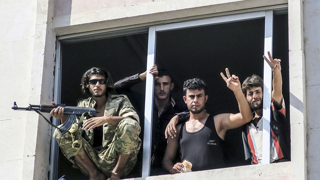 <p>Free Syrian Army fighters give the victory sign, in Jarablus, Syria. Veteran Syrian rebels who have fought Assad for years are struggling to find a place in a bewildering battlefield where several wars are all being waged at once by international powers. Battered by defeats, they bounce from alliance to alliance, feeling abandoned by the U.S. and faced with choosing whether to ally with Turkey or al-Qaida. (AP Photo, File)</p>
