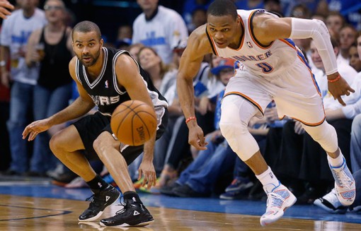 San Antonio Spurs guard Tony Parker, left, and Oklahoma City Thunder guard Russell Westbrook  watch a loose ball in  Game 4 of the Western Conference finals Tuesday in Oklahoma City. (Sue Ogrocki/The Associated Press)