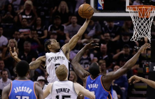 San Antonio Spurs Kawhi Leonard grabs a defensive rebound against the Oklahoma City Thunder during the first half of Game 5 of the Western Conference finals NBA basketball playoff series, Thursday, May 29, 2014, in San Antonio. (AP Photo/Eric Gay)