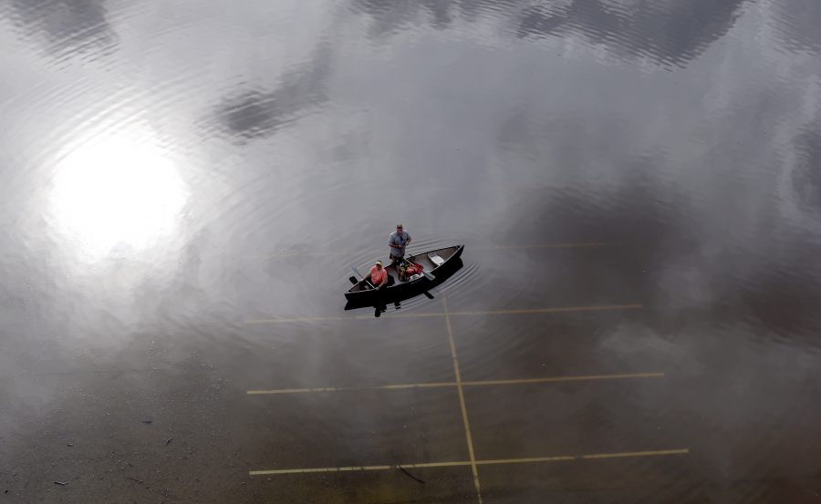 AP10ThingsToSee - In this aerial photo, people prepare to launch a canoe from a flooded parking lot near Bear Creek Park Saturday, May 30, 2015, in Houston. (AP Photo/David J. Phillip, File)