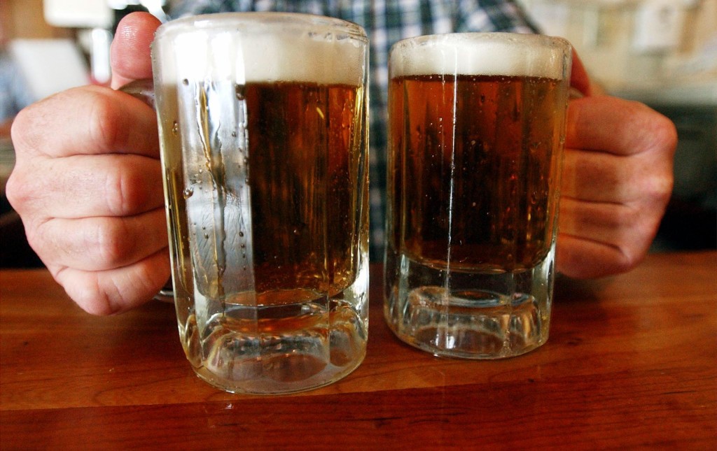 A bartender serves two mugs of beer at a tavern in Montpelier, Vt in this June 29, 2004 photo. Alcohol problems affect almost 33 million adults and most have never sought treatment. (AP Photo/Toby Talbot)