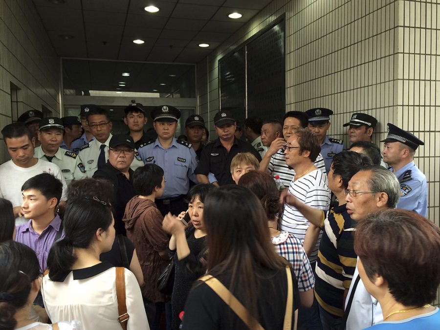 Relatives of Shanghai passengers on board a cruise ship that capsized in central China, attempt to storm a government office to demand for action after the tourist agency which organized the tour failed to help them, in Shanghai, China, Tuesday, June 2, 2015. Such quick outrage mirrors the responses of victims relatives from other recent disasters such as last year’s disappearance of Malaysian Airlines Flight 370, which carried hundreds of Chinese travelers when it vanished from radars. (AP Photo)