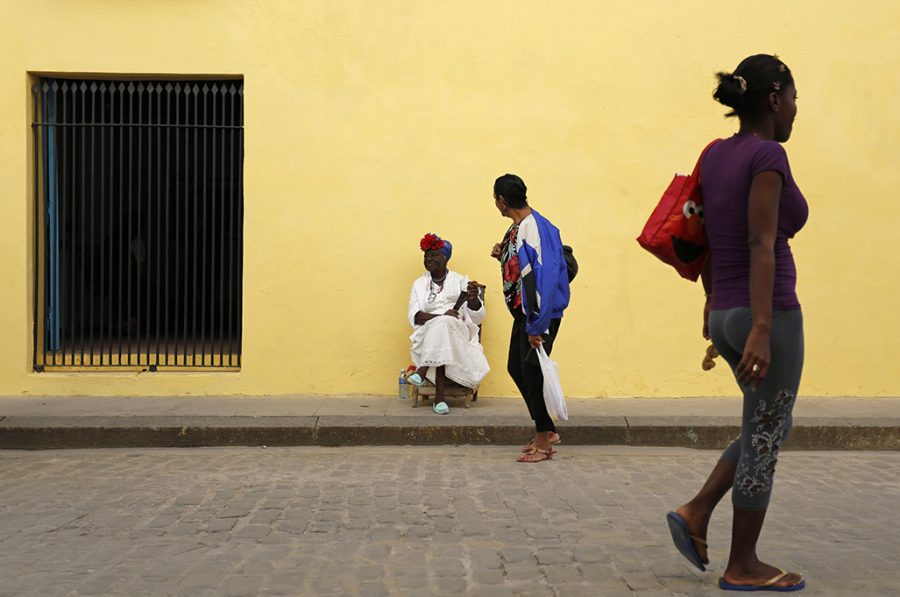 In this Dec. 19, 2014 file photo - A street entertainer waits for tourists in Old Havana, Cuba. The thawing of U.S.-Cuba relations has inspired many Cubans to think big. Visits by Americans were up 36 percent between January and early May of 2015 compared to the same period a year ago, and up 14 percent among all international arrivals. That surge is likely to continue as interest in the destination grows and it gets easier for Americans to travel there. (AP Photo/Desmond Boylan, File)