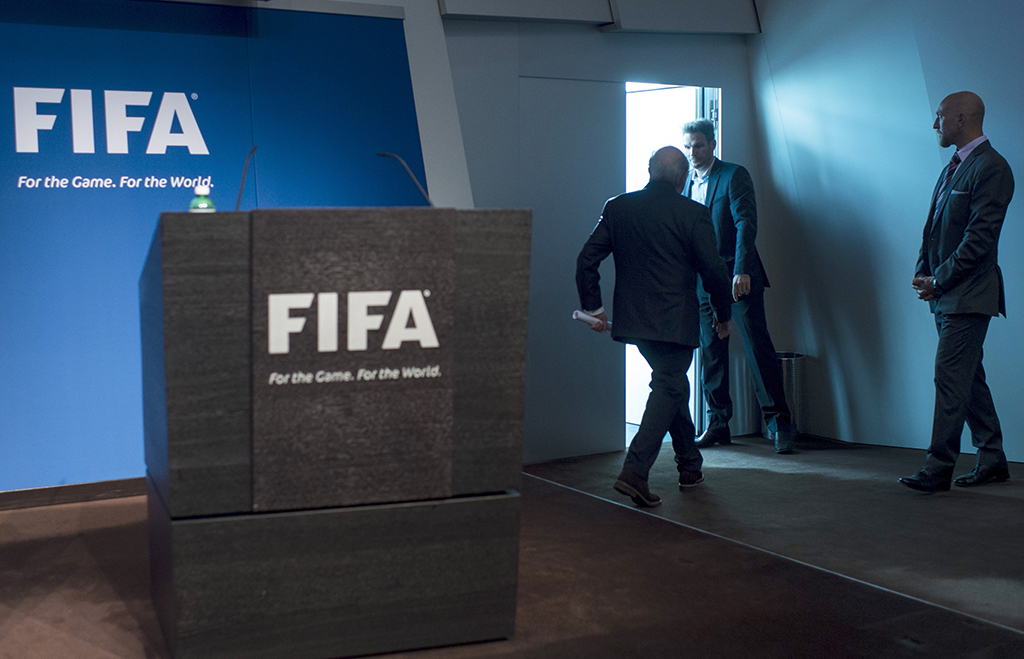 FIFA President Sepp Blatter leaves after speaking at a press conference at the FIFA headquarters in Zurich, Switzerland, Tuesday, June 2, 2015. Sepp Blatter says he will resign from his position amid corruption scandal and is promising to call for fresh elections to choose a successor. (Ennio Leanza/Keystone via AP)