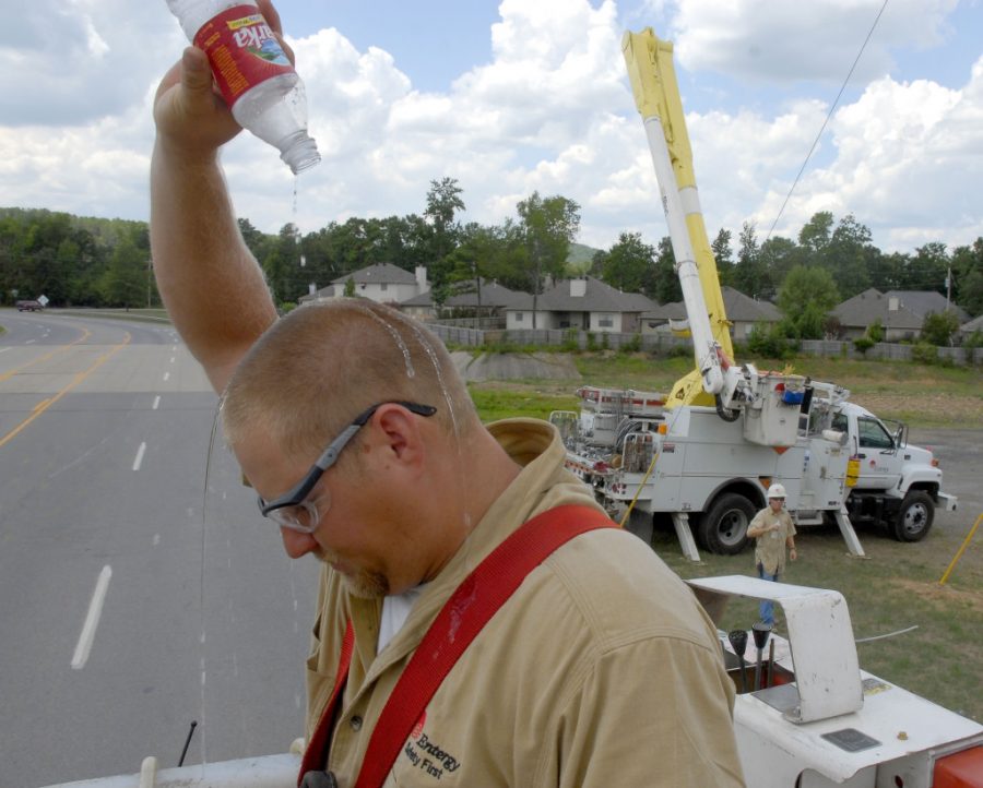 Gabe Lentz, a lineman with Entergy Arkansas, pours water over his head to cool off , in Little Rock, Ark., as temperatures reached well into the 90s in this Aug. 8, 2006 file photo. (AP Photo/Mike Wintroath)