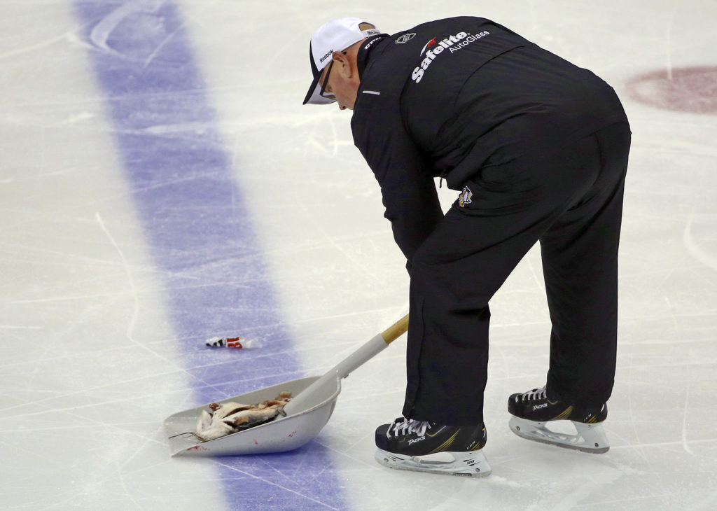 <p>An ice worker removes a fish during the second period of Game 1 of the NHL hockey Stanley Cup Finals between the Pittsburgh Penguins and Nashville Predators on May 29.</p>