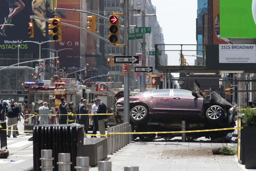 <p>FILE - In this Thursday, May 18, 2017 file photo, a car rests on a security barrier in New York's Times Square after driving through a crowd of pedestrians, injuring at least a dozen people. A three-foot-tall piece of stainless steel in the ground ultimately stopped a speeding Honda Accord as it barreled down the crowded sidewalks of Times Square this week. The vehicle rampage that killed a teenage tourist in New York's Times Square is spurring calls to further restrict cars from the so-called Crossroads of the World. (AP Photo/Mary Altaffer, File)</p>