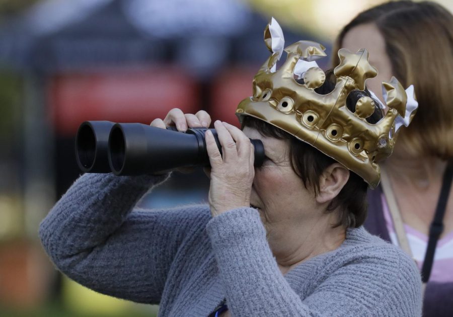 Woman with inflatable crown and binoculars