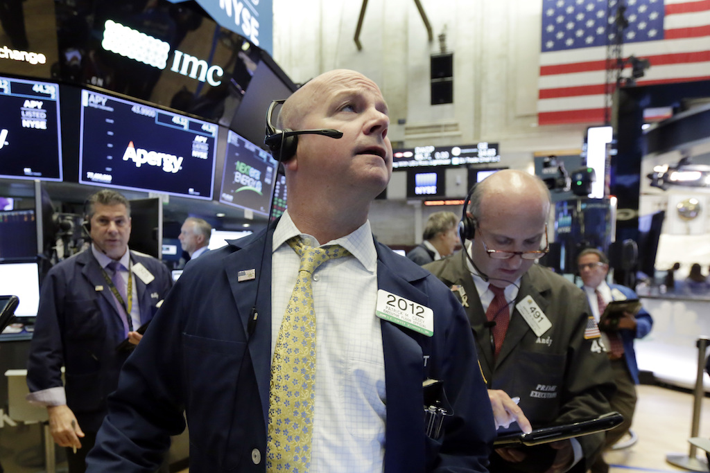 Trader Patrick Casey, center, works on the floor of the New York Stock Exchange, Tuesday, May 29, 2018. U.S. stocks are opening lower, following sharp drops in Europe triggered by political uncertainty in Italy.