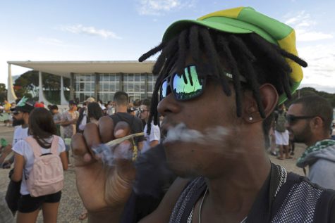 A young man smokes marijuana