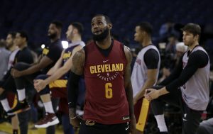 Cleveland Cavaliers LeBron James watches his shot as his teammates stretch behind him during an NBA basketball practice, Wednesday, May 30, 2018, in Oakland, Calif. The Cavaliers face the Golden State Warriors in Game 1 of the NBA Finals on Thursday in Oakland. (AP Photo/Marcio Jose Sanchez)