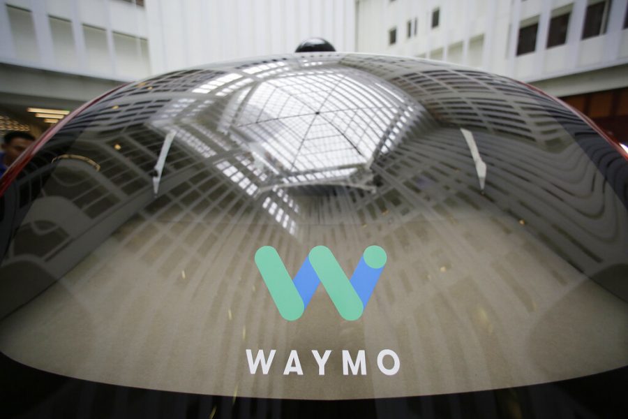 A skylight is reflected in the rear window of a Waymo driverless car during a Google event Dec. 13, 2016, in San Francisco. Googles self-driving vehicle division says its bringing autonomous trucks to the Phoenix area. Waymo announced May 30 that its fully self-driving tractor-trailers will start driving on freeways this week and will expand to more routes over time.