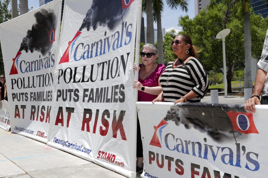 Protestors with Stand.earth hold a banner in opposition to Carnival Corp. outside of federal court, Monday, June 3, 2019, in Miami. Carnival Corp. is in federal court for a hearing on what to do about allegations that it has continued polluting the oceans from some of its cruise ships despite agreeing years ago to stop (AP Photo/Lynne Sladky)