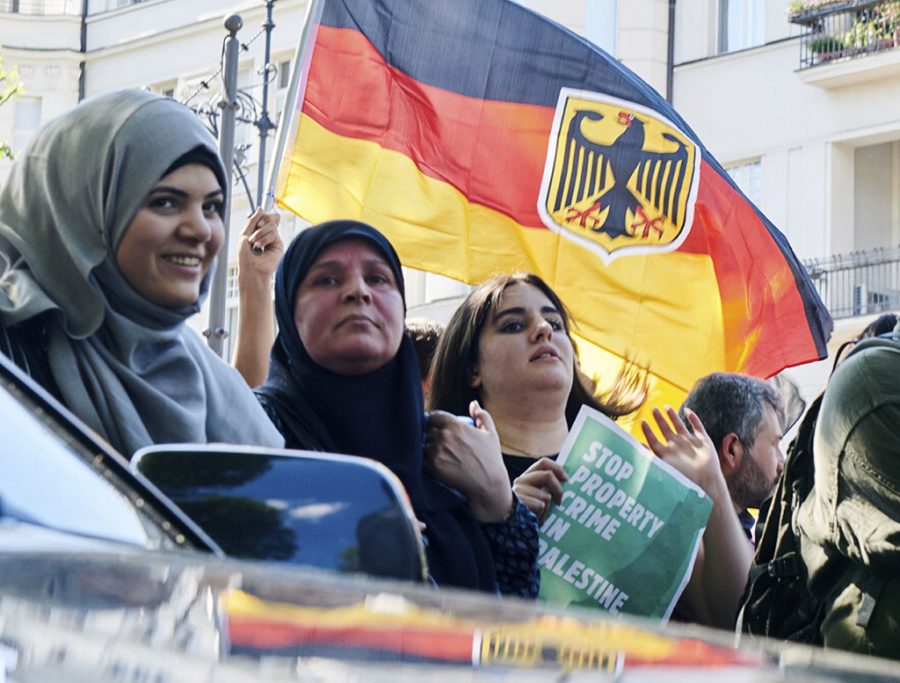 Participants wave a German flag
