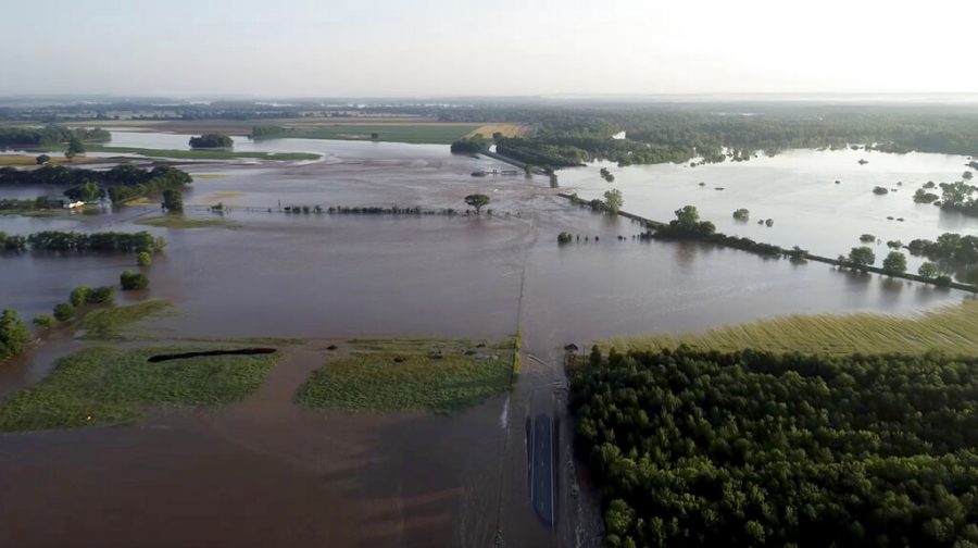 In this aerial image provided by Yell County Sheriffs Department water rushes through the levee along Arkansas River in Dardanelle, Ark., on Friday, May 31, 2019. Officials say the levee breached early Friday at Dardanelle, about 60 miles northwest of Little Rock. (Yell County Sheriffs Department via AP)