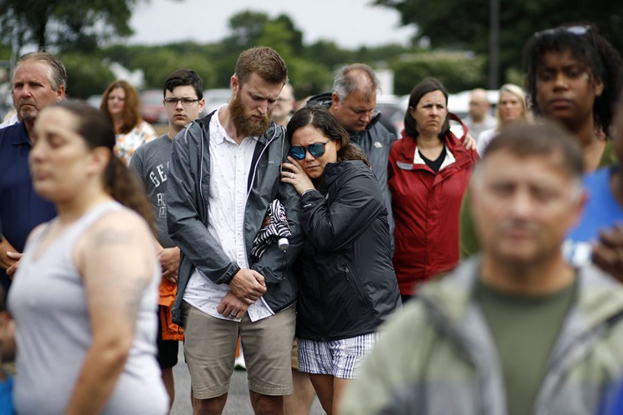 Brittany Myers, right, embraces her husband, Ryan, during a vigil for the Virginia Beach shooting victims