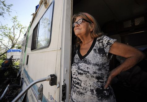 woman looking out from her trailer
