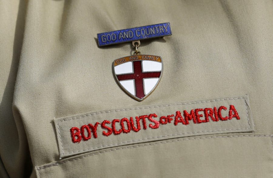 This photo shows a close up of a Boy Scout uniform badge during a news conference in front of the Boy Scouts of America headquarters in Irving, Texas. Victims of childhood sex abuse suing the Boy Scouts of America in New Jersey, New York, California and a handful of other states that loosened their statutes of limitations in 2019 will effectively face an earlier deadline to press claims because of a date set in federal bankruptcy proceedings. 