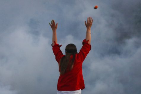 A rubber bullet is fired over a protester by police.