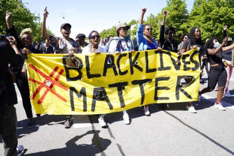 Protesters carry a Black Lives Matter banner