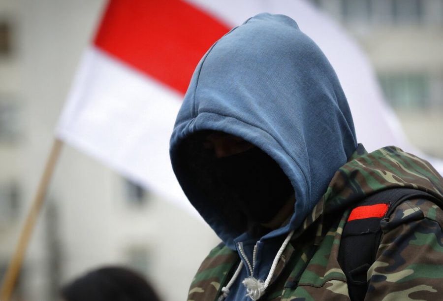 A man with a hood over his face protests in Belarus.