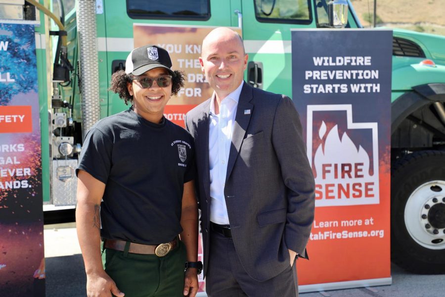 Utah Gov. Spencer Cox stands with resident during wildfire campaign.