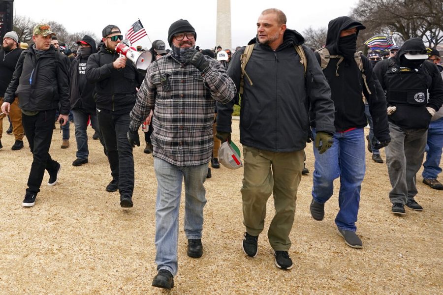 FILE - In this Jan. 6, 2021, file photo, Proud Boys including Joseph Biggs, front left, walks toward the U.S. Capitol in Washington, in support of President Donald Trump. With the megaphone is Ethan Nordean, second from left. Outside pressures and internal strife are roiling two far-right extremist groups after members were charged in the attack on the U.S. Capitol. Former President Donald Trump’s lies about a stolen 2020 election united an array of right-wing supporters, conspiracy theorists and militants on Jan. 6.  (AP Photo/Carolyn Kaster, file)