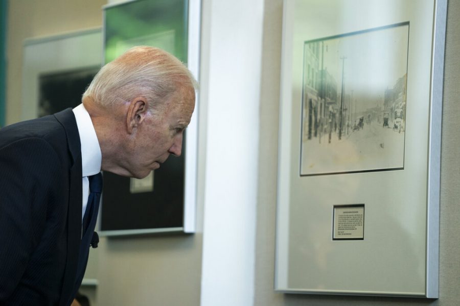 Joe Biden looks at photo during tour of Greenwood Cultural Center