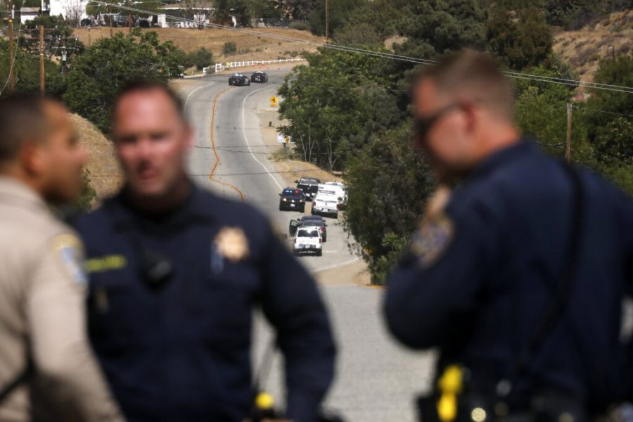 Law enforcement authorities close off a road during an investigation for a shooting at fire station 81 in Santa Clarita, Calif. on Tuesday, June 1, 2021. An off-duty Los Angeles County firefighter fatally shot a fellow firefighter and wounded another at their fire station Tuesday before barricading himself at his home nearby, where a fire erupted and he was later found dead, authorities said. (AP Photo/David Swanson)