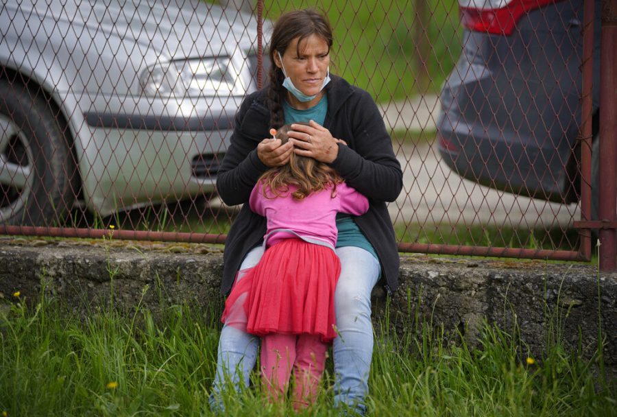 A woman comforts her daughter after she was slightly hit by a ball while playing.