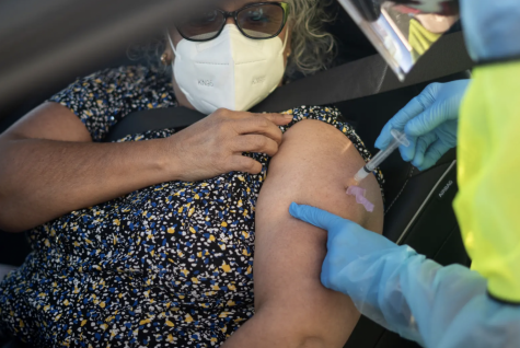 Blanca Alvarado administers the COVID-19 vaccine to a patient in Laredo on Feb. 1.