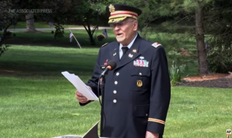 Retired Army Lt. Col. Barnard Kemter reading the speech at a park.