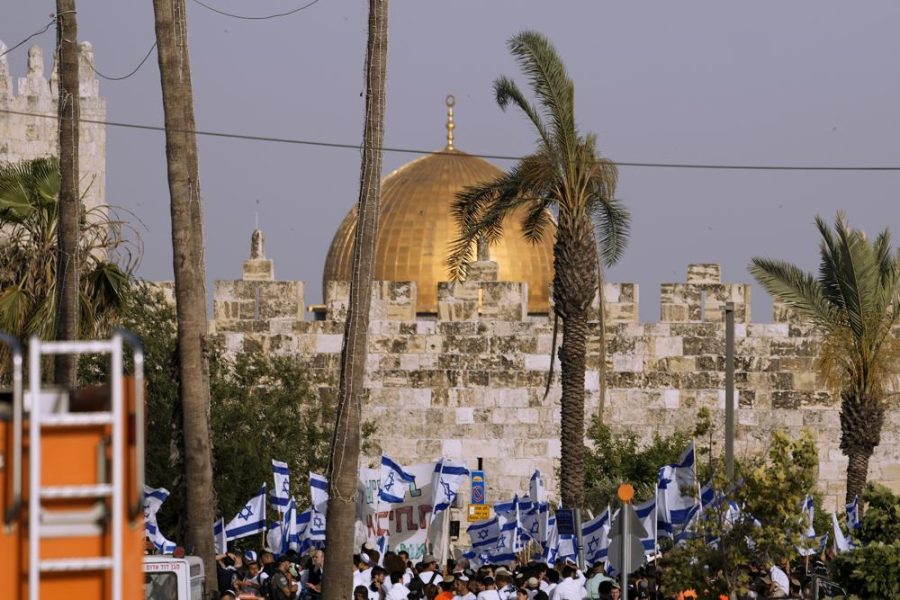 Israelis wave national flags in front of Damascus Gate.