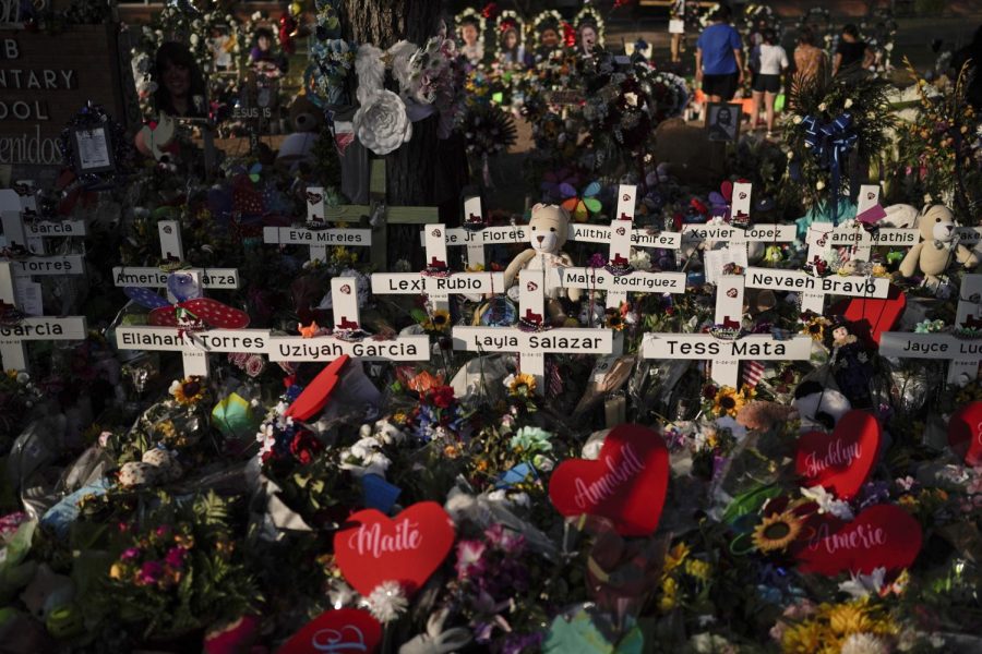 Flowers pile around crosses with the names of the victims killed in last weeks school shooting at Robb Elementary School as people pay their respects, Tuesday. JAE C. HONG/Associated Press