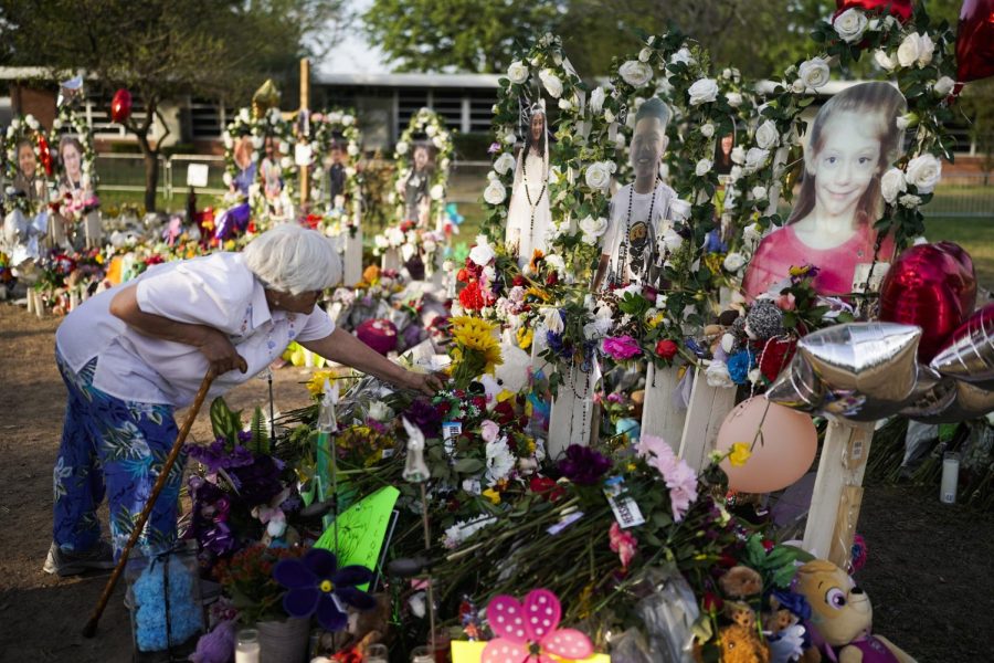 Socorro Valencia, 78, lays flowers at a memorial at Robb Elementary School in Uvalde, Texas, Tuesday, to honor the victims killed in last weeks school shooting. 