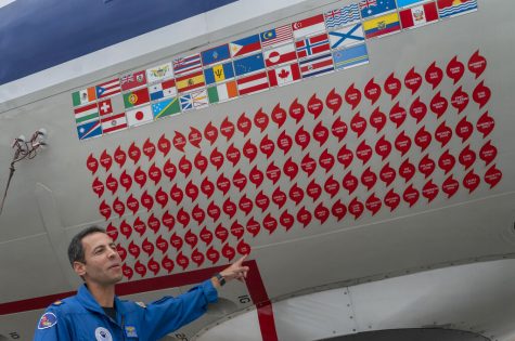 Lt. Commander Sam Urato of the National Oceanic and Atmospheric Administration is pointing at the hurricane hunter aircraft.