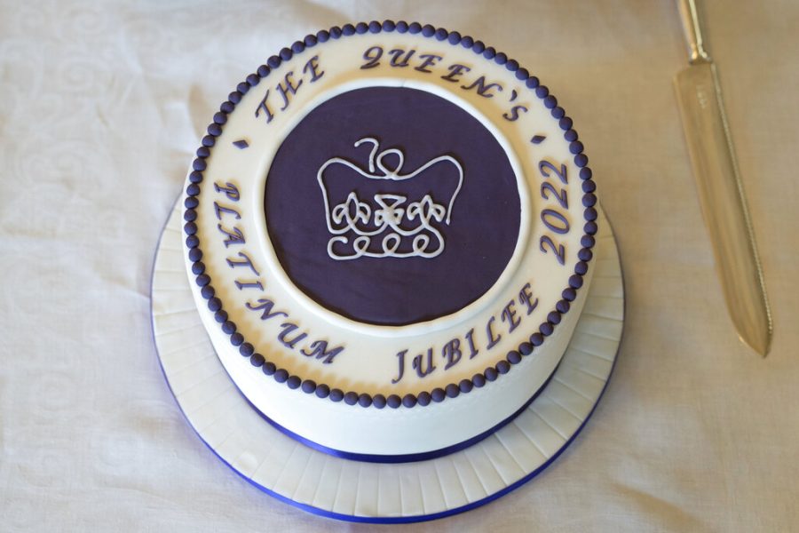 FILE - A cake to celebrate the start of Britains Queen Elizabeths Platinum Jubilee, at a reception she held for representatives from local community groups to commemorate her 70th years on the throne at Sandringham, England, Saturday, Feb. 5, 2022. Britain is getting ready for a party featuring mounted troops, solemn prayers — and a pack of dancing mechanical corgis. The nation will celebrate Queen Elizabeth II’s 70 years on the throne this week with four days of pomp and pageantry in central London.  (Joe Giddens/Pool Photo via AP, File)