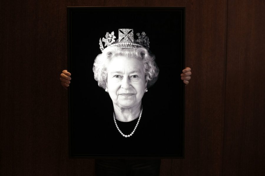 FILE - Rob Munday, creator of the first officially commissioned 3D/holographic portrait of Britains Queen Elizabeth II in 2004, unveils a previously unseen portrait of the monarch to celebrate the Platinum Jubilee, in London, Wednesday, May 4, 2022. Britain is getting ready for a party featuring mounted troops, solemn prayers — and a pack of dancing mechanical corgis. The nation will celebrate Queen Elizabeth II’s 70 years on the throne this week with four days of pomp and pageantry in central London. (AP Photo/Kirsty Wigglesworth, File)