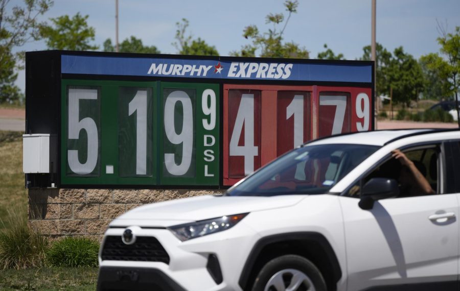 Gasoline prices are displayed outside a convenience store as a motorist drives by May 26 in Thornton, Colorado. 