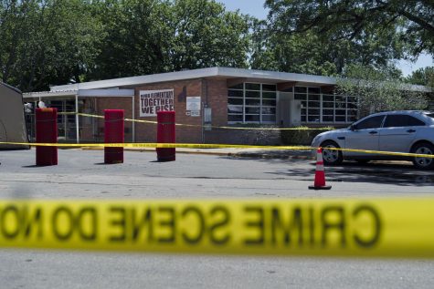 FILE - Crime scene tape surrounds Robb Elementary School in Uvalde, May 25. When the gunman arrived at the school, he hopped its fence and easily entered through an unlocked back door, police said. He holed himself up in a fourth-grade classroom where he killed the children and teachers. 