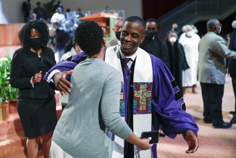 Rev. Dante Quick, greets people as he preaches during a church service at the First Baptist Church of Lincoln Gardens on May 22 in Somerset, N.J.