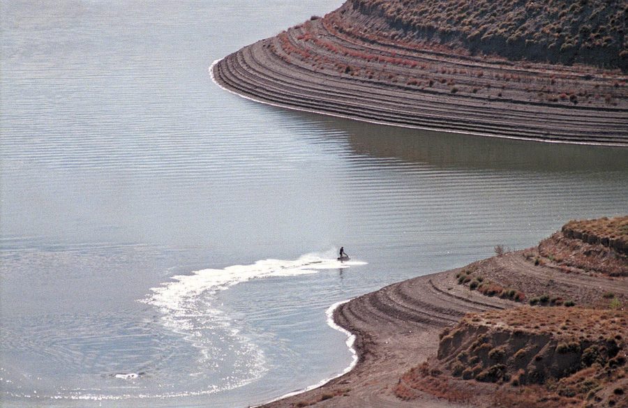 A man rides his personal water craft along the shore of Lake Pueblo 