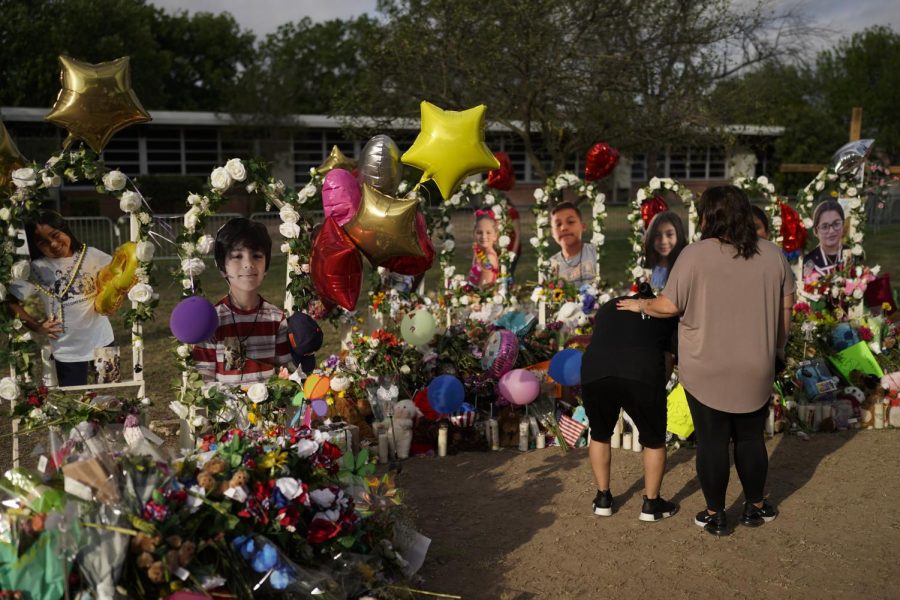 Jolean Olvedo, left, weeps while being comforted by her partner Natalia Gutierrez at a memorial for Robb Elementary School students and teachers who were killed in last weeks school shooting in Uvalde, Texas, Tuesday, May 31.