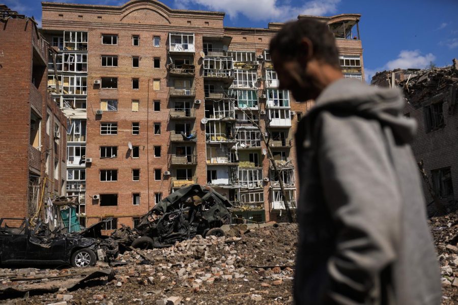 A man walks next to heavily damaged buildings and destroyed cars following Russian attacks in Bakhmut in the Donetsk region in eastern Ukraine on May 24. The region, along with neighboring Luhansk, is part of the Donbas, where Russian forces have focused their offensive.