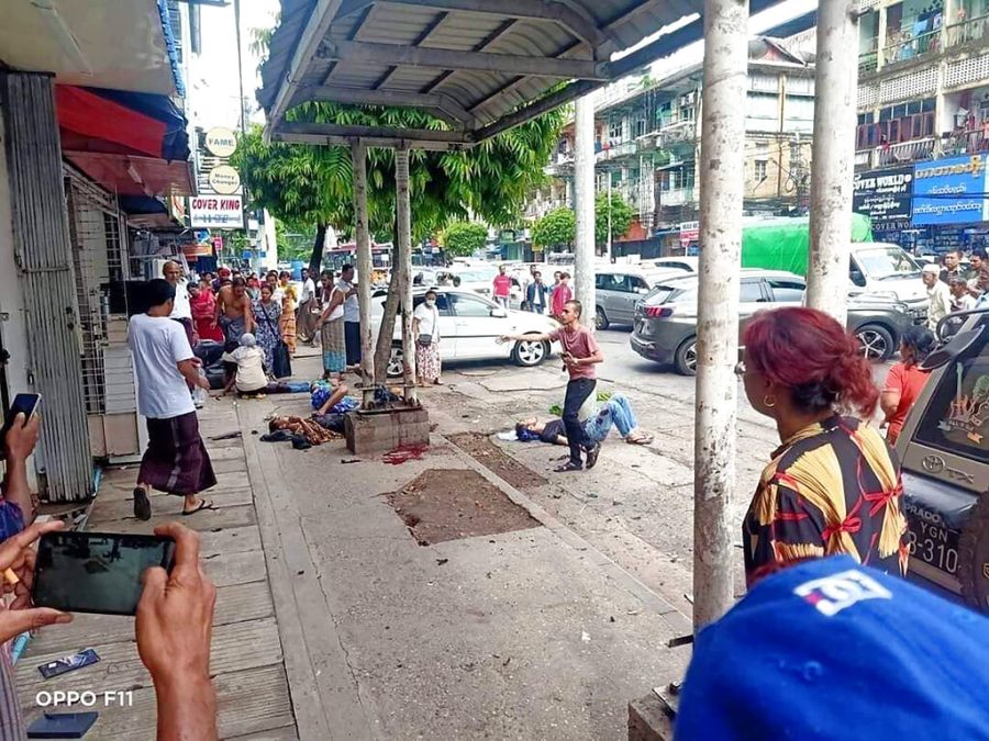 Four+injured+people+lying+on+the+ground+after+the+explosion+at+the+bus+stop+in+Yangon%2C+Myanmar.
