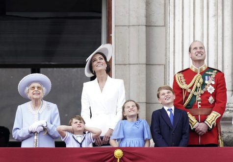 Queen Elizabeth II, Kate, Duchess of Cambridge, Prince Louis, Princess Charlotte, Prince George, and Prince William watch from the balcony of Buckingham Place.