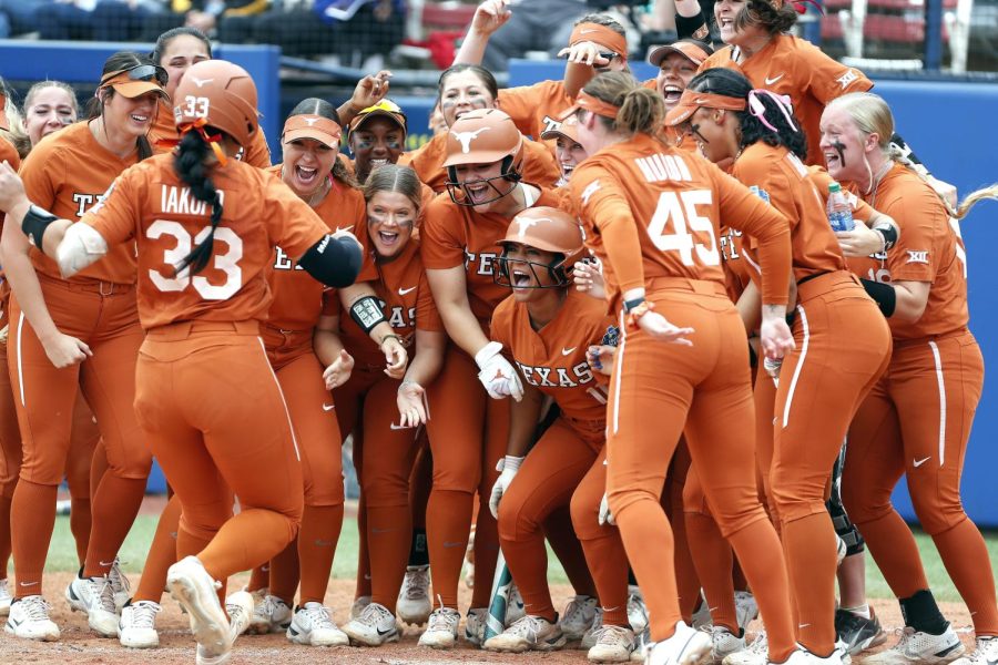 University+of+Texas+softball+players+celebrate+a+home+run+during+the+opening+game+of+the+Womens+College+World+Series.