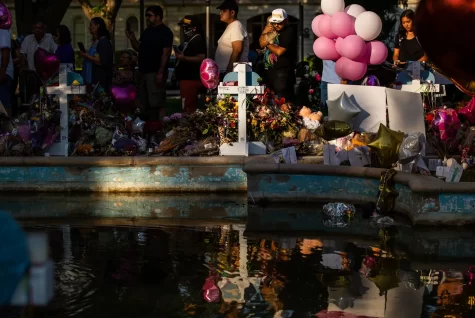 Thousands of roses and handwritten notes, hundreds of candles and dozens of stuffed animals surround a fountain in the center of Uvalde’s Town Square on May 29, 2022.